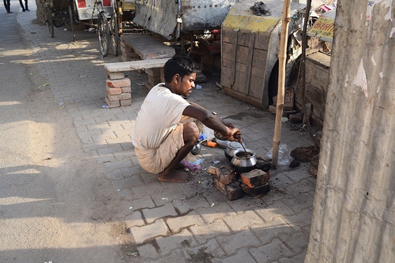 Indian man cooking streetside