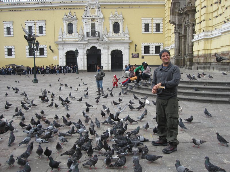 Scott feeding pigeons in the Convent  San Fransicso grounds