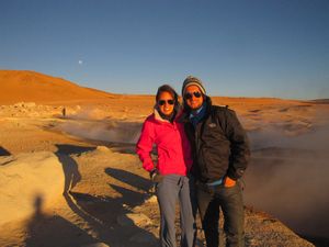 Us at sunrise with moon in background at the geysers