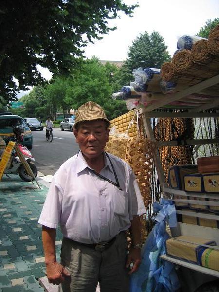 Man selling cane pillows