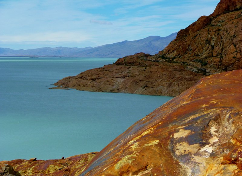 fabulous contrasts of the turquoise glacial lake and mineral-covered rhyolite rocks