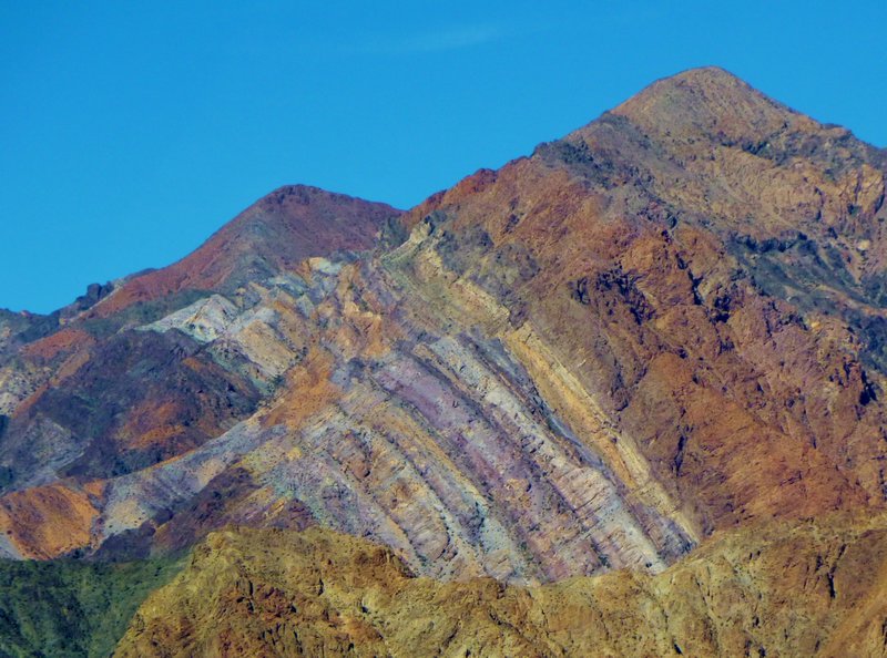 wildly colored, intruding strata of rocks