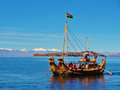 Titicaca traditional reed boat with snowyAndes