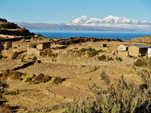 terraces, brown in the dry season, adobe houses, snowy Andes