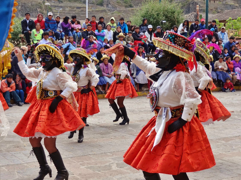 black-masked dancers and local spectators