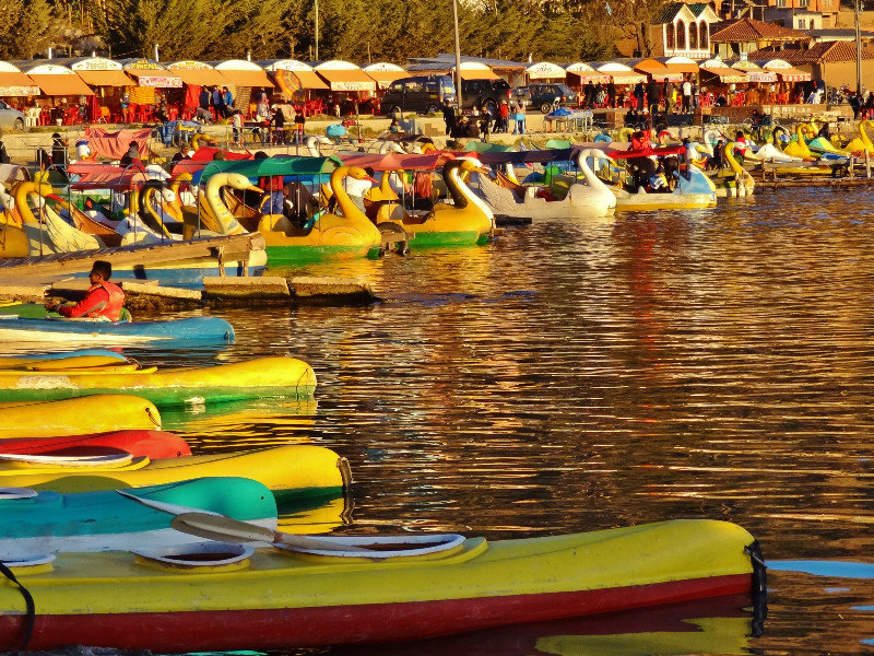 lake front with colorful kayaks & paddle boats