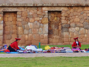 selling textiles in plaza in front of Incan wall