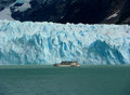 big boat dwarfed by glacier