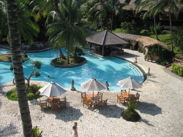 pool area with massage huts and pool bar