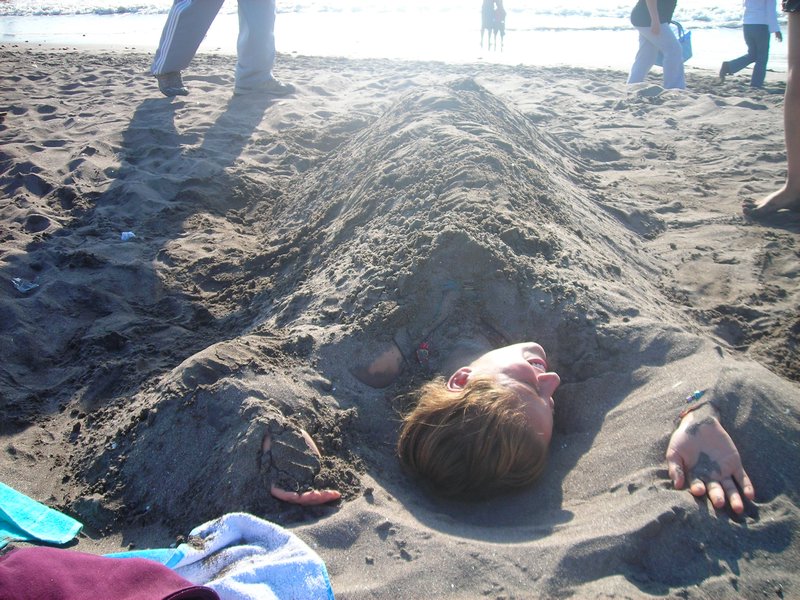Kayley buried in sand