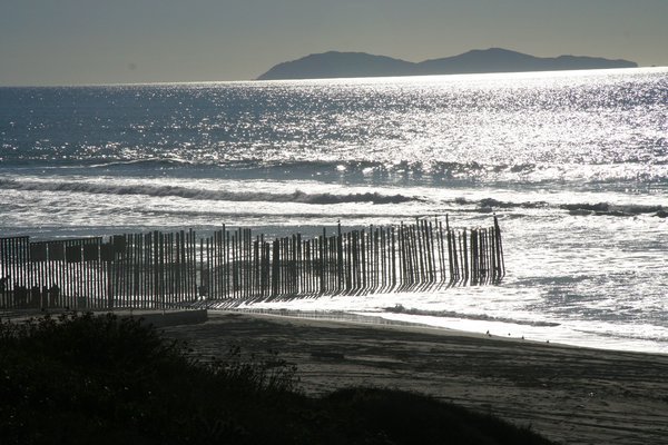 The border fence running a little into the ocean