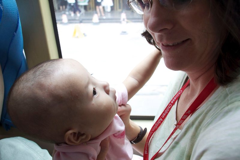 Julia gazing at Mama on the bus home from signing the adoptive paperwork.