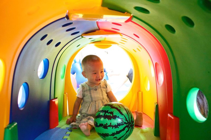 Baby Julia having fun in a toddler tunnel.