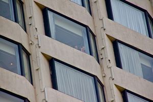 Emma & Josh waving from the hotel room window.