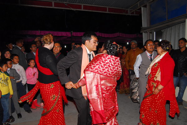 Three brothers and their wife dancing in the wedding party