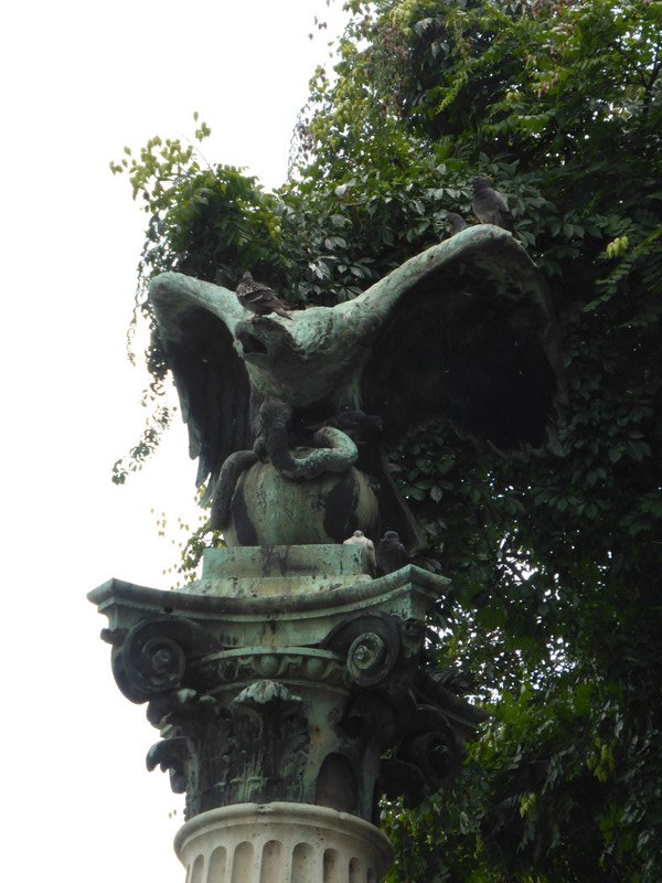 Amused by birds perching on the statue of an eagle!