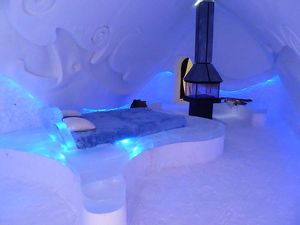 Hotel de Glace - one of the hotel rooms with a fire place
