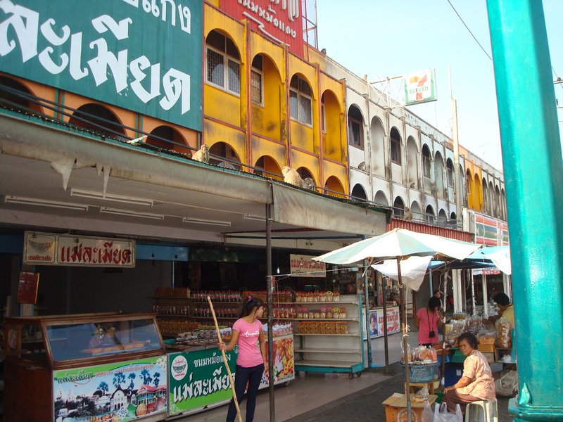 Phetburi - Storekeeper with stick to ward off monkeys