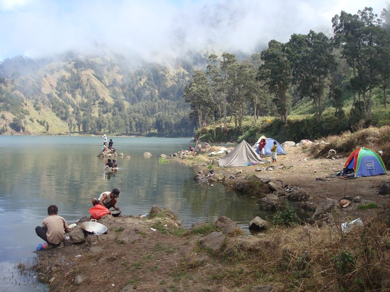 Indonesian tourists camping by lake