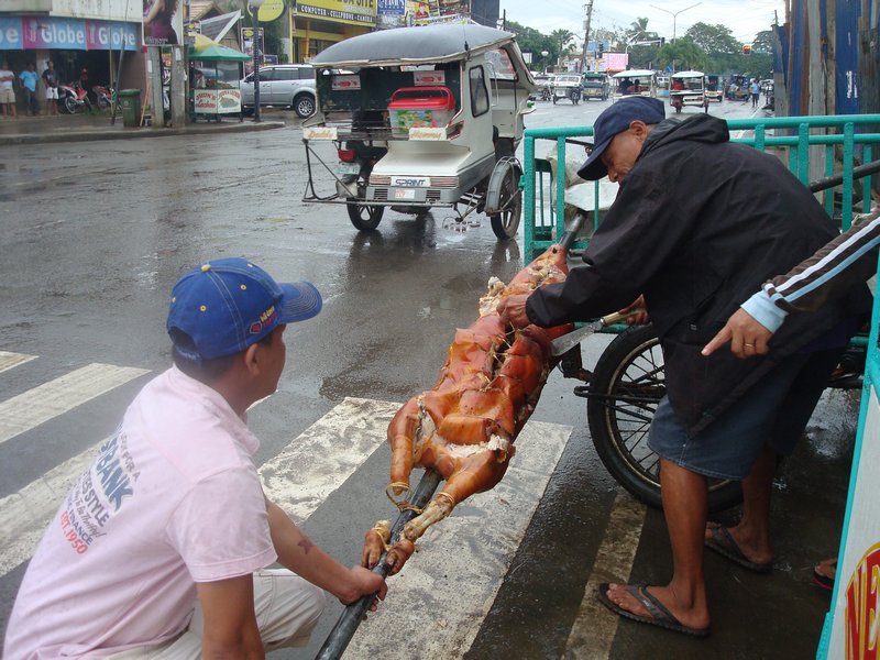 Cutting up a cooked pig in Puerto Princesa