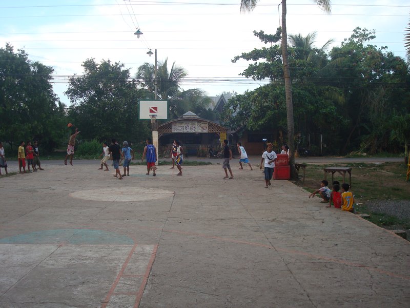 Locals playing basketball in the evening