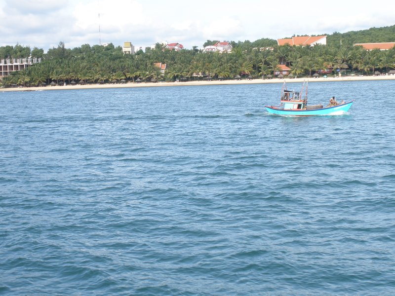 Fisherman in his Junk with the Resort in the background