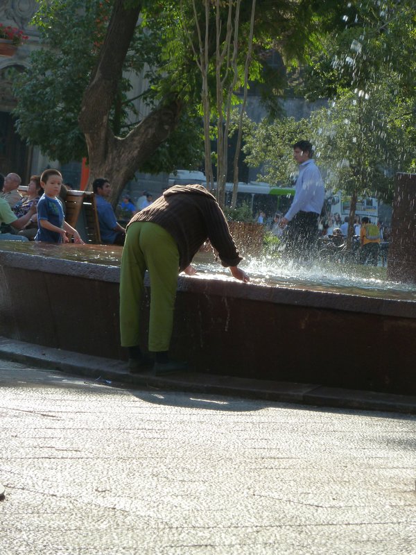 Lady washing her hair in the fountain! 
