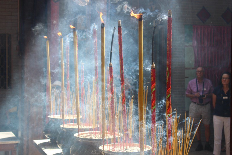 Burning incense sticks at Thien Hau Pagoda