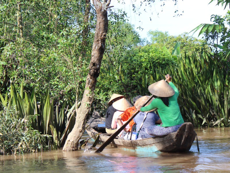 Sampan ride along a canal, heading towards the Mekong