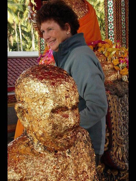 Mom Putting Gold Leaf On The Buddha