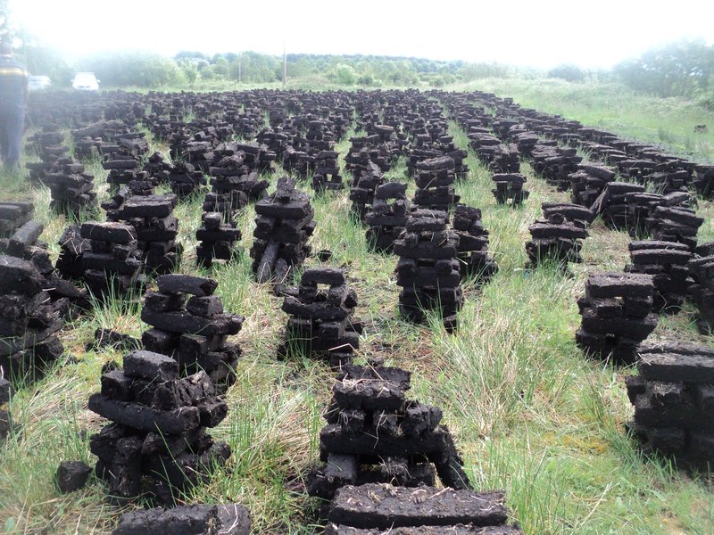 A field of stacked turf drying
