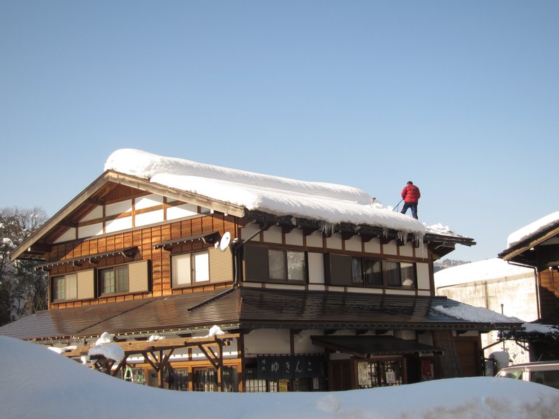 Shovelling snow off roof