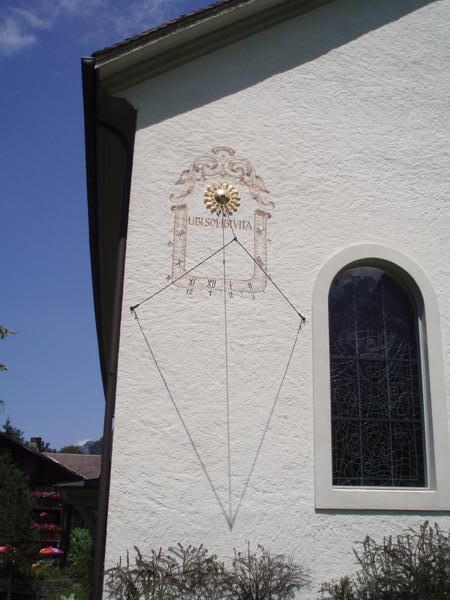 time-piece on the side of a church