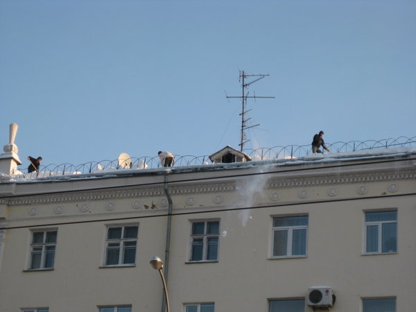 Workers Throwing Snow off Roof in Yekaterinburg