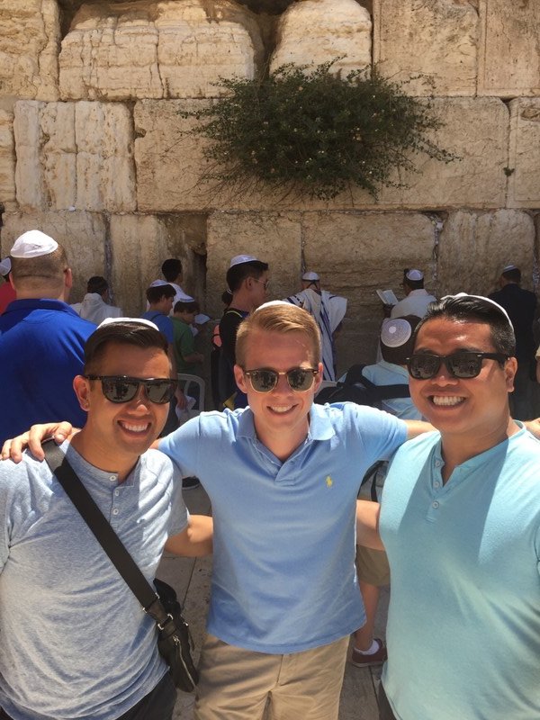 With our kippahs in front of the wall