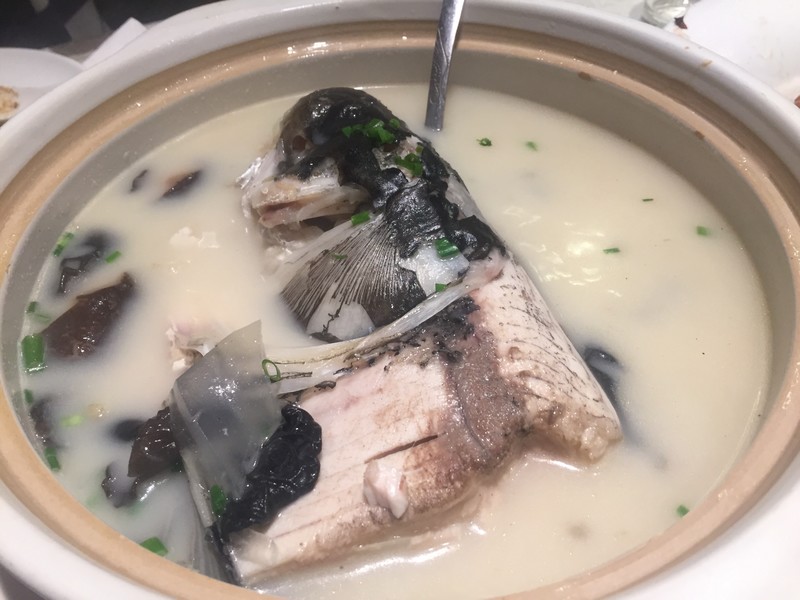 Soup with a giant carp floating in it 