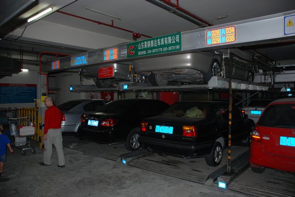 Chinese parking garage - you drive up on a platform and the car elevator lifts your car up to the top and makes room for another!