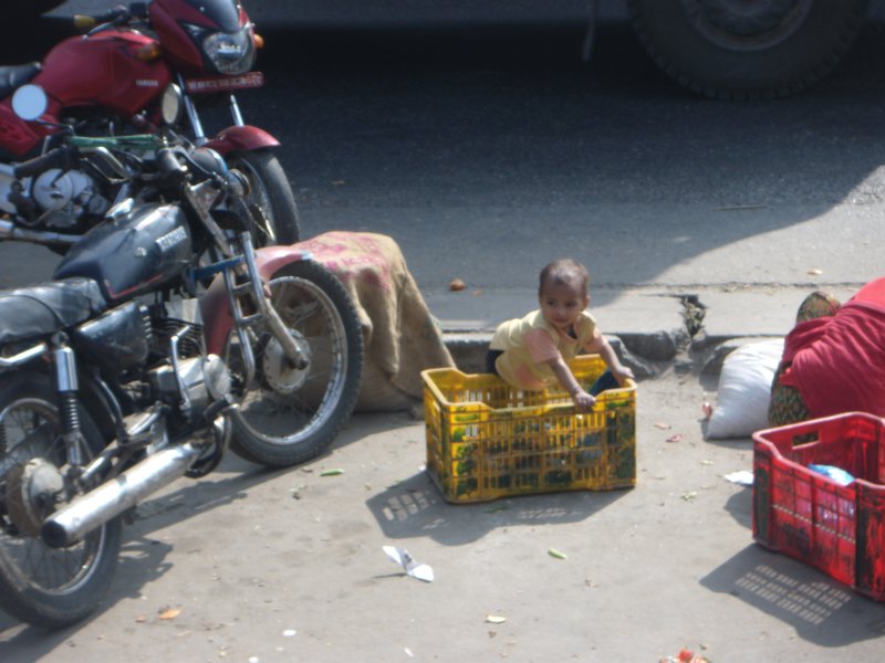 Baby Playing Next to a Major Road