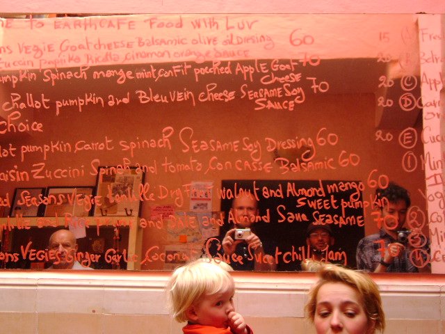 Menu in Earth Café vegan joint; me and friends reflected