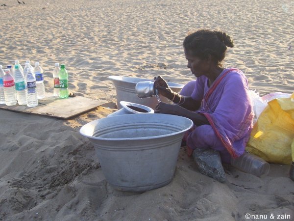 A woman filling water bottles - Marina Beach