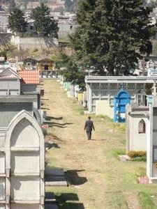 Old man walking in grave yard