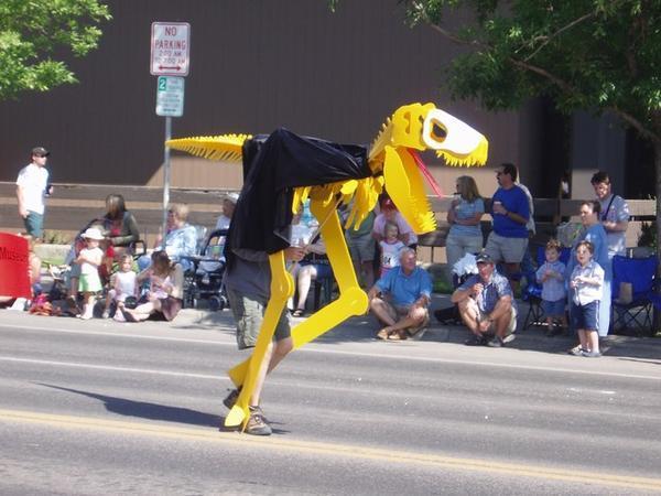 A man in a yellow T-Rex suit
