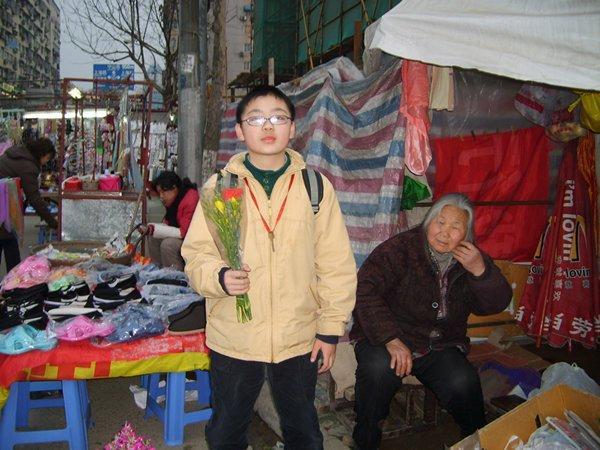 Young boy buying flowers for his mother