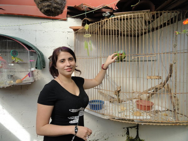 Maria Elena, daughter, with one of their several birds