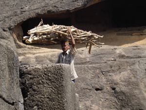 Man carrying wood at the caves