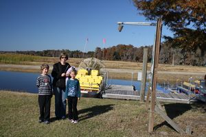 The family in front of the airboat..