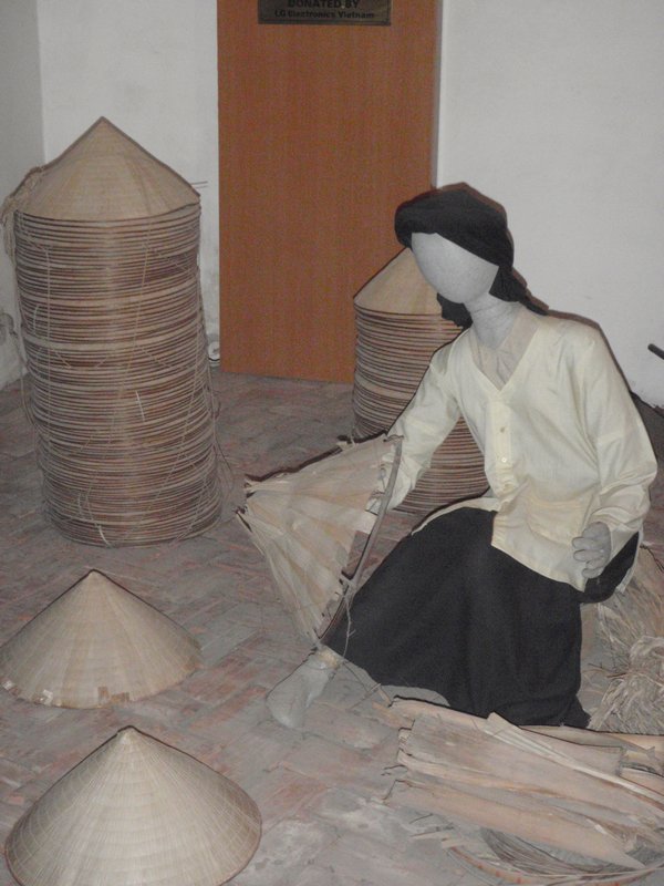 Woman making conical hat
