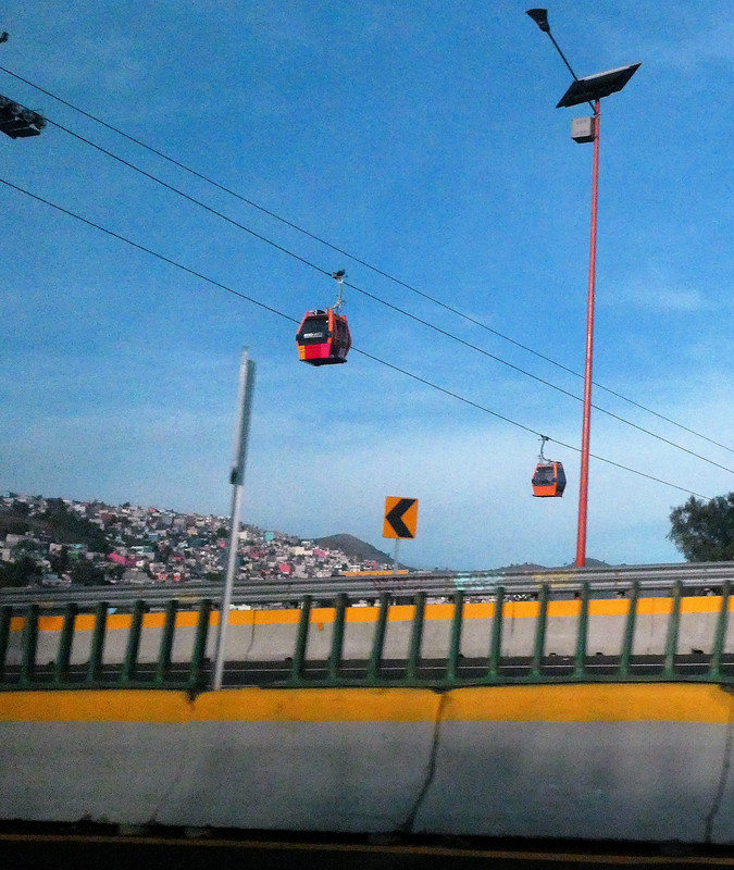 Cable Car going across highwa outside Mexico City from the colourful hillside district
