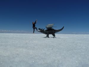 Pam jumping over a dinosaur on the Salar