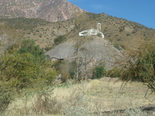 Church on top of hill + house built in same hill